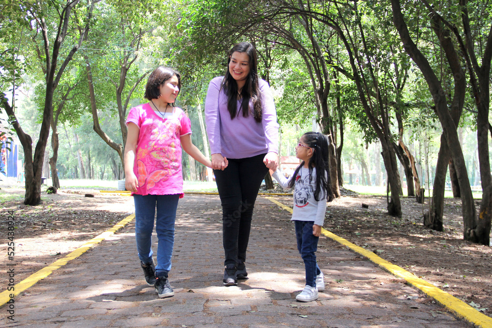 Single and divorced Latin mom and daughters walk in the park outdoors alone spend quality family time on summer vacation or weekend
Single and divorced Latin mom and daughters walk in the park outdoors alone spend quality family time on summer vacation or weekend