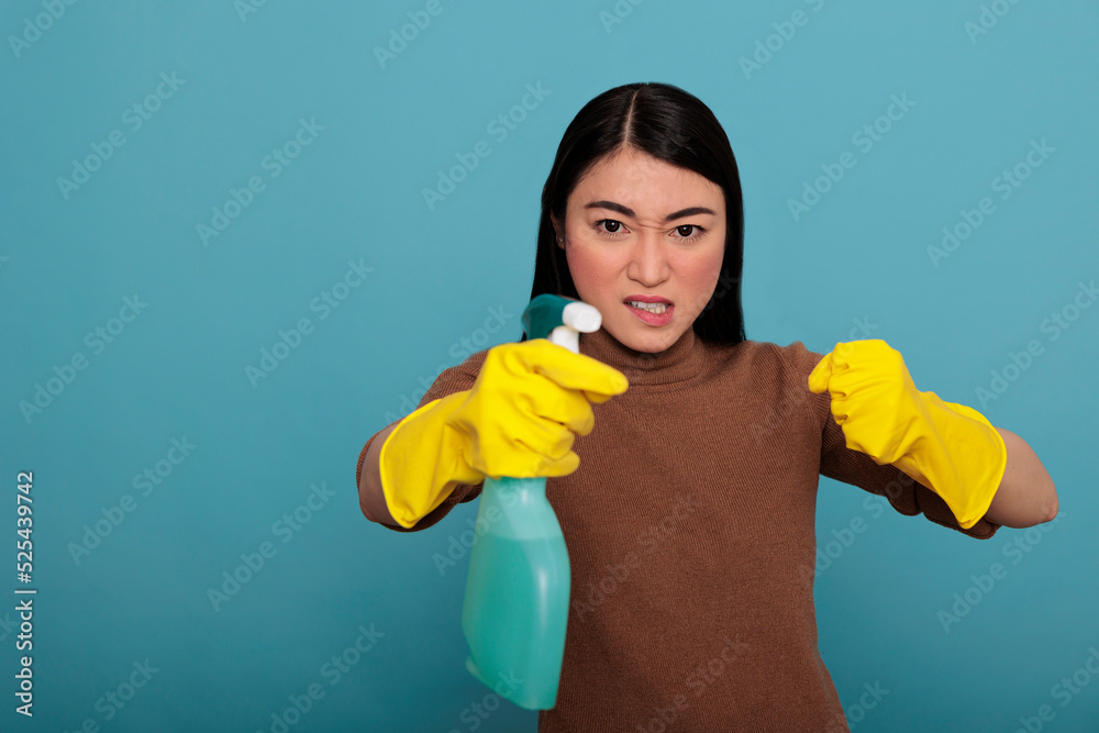 Excited energetic asian young housekeeper in rubber gloves and detergent spray standing in a fight pose, Cleaning home concept, Confidence housekeeper feeling negative at work Excited energetic asian young housekeeper in rubber gloves and detergent spray standing in a fight pose, Cleaning home concept, Confidence housekeeper feeling negative at work