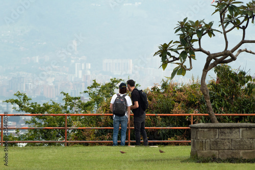 Two unrecognizable men looking at a city skyline out of focus © Andres Serna
