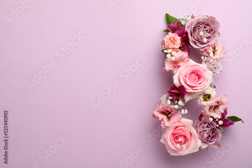 Number 8 made of beautiful flowers on violet background, flat lay with space for text. International Women's day