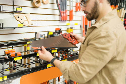 Caucasian male carpenter shopping for new tools