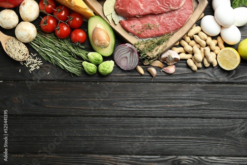 Flat lay composition with fresh meat and other products on wooden table, space for text. Balanced diet