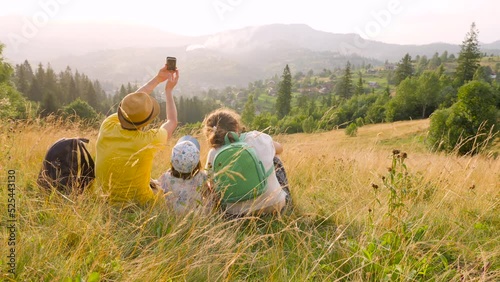 Young parents caucasian baby travel mountain vacation time together holiday park phone photo. Caucasian family outdoors young family taking photo family mountain phone mobile mountain walking together