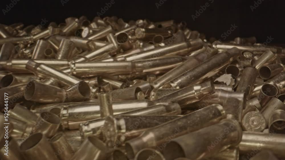 Beautiful dolly in over spent bullet shells. Stunning macro shot of brass shell cases