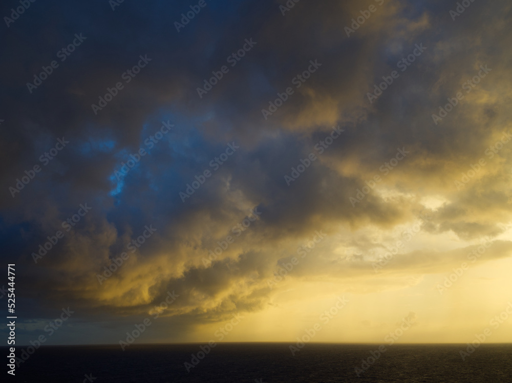 Open ocean thunderstorm edge at sunrise. Graphic sky, natural background