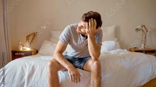 Φωτογραφία Depression, mental health and sad man in stress feeling bad, upset and depressed alone in his home, house or hotel suite