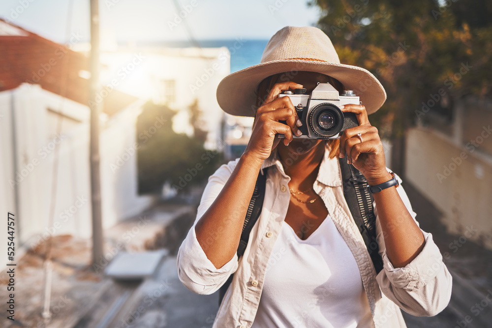 Photographer, travel or tourist taking pictures or photos outdoors in a new town. Traveler using a camera while on a trip at a vacation or holiday location on a sunny day doing a photoshoot - obrazy, fototapety, plakaty 