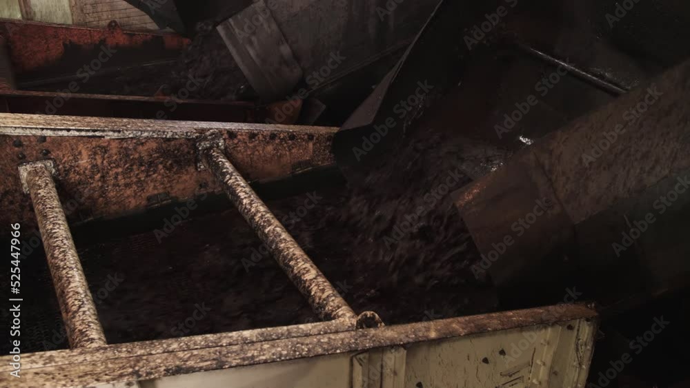 Mixture of coal and water is poured from pipe onto vibrating screen. Water slurry circuit, coal preparation facilties Mixture of coal and water is poured from pipe onto vibrating screen. Water slurry circuit, coal preparation facilties