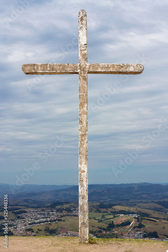 Old White Cross on the hill with a very clody and greyd blue skye on Morro Pelado at Aguas de Lindoia - Brazil photo