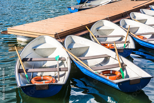 Paddle boats with lifebuoy inside docked to the jetty