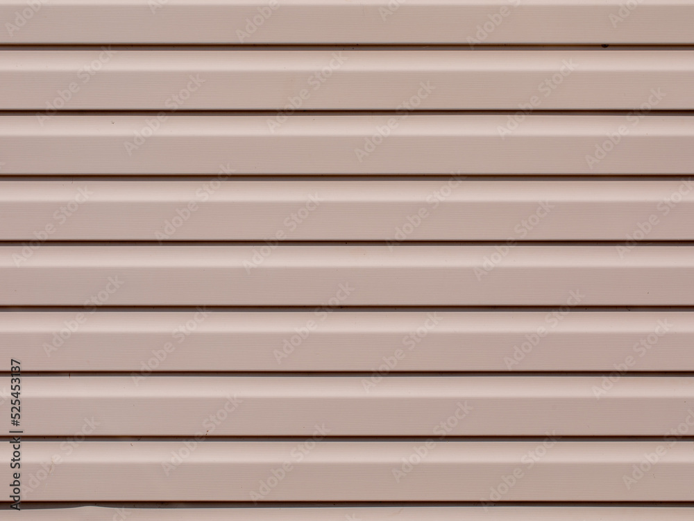 Plastic siding surface in pink tone. House wall, abstract background and texture Plastic siding surface in pink tone. House wall, abstract background and texture