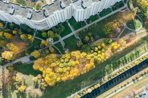 aerial view of apartment buildings near water canal in sunny autumn day