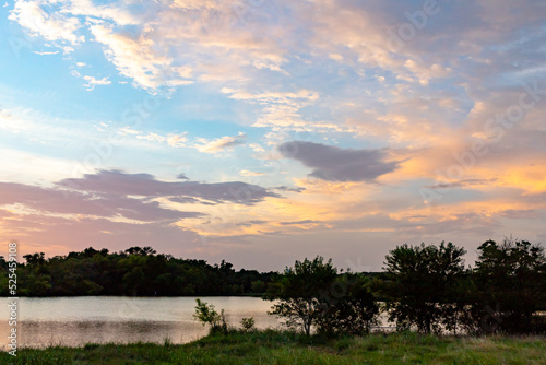 Dramatic sunset clouds lake reflection on Woodlawn Lake San Antonio Texas	 photo