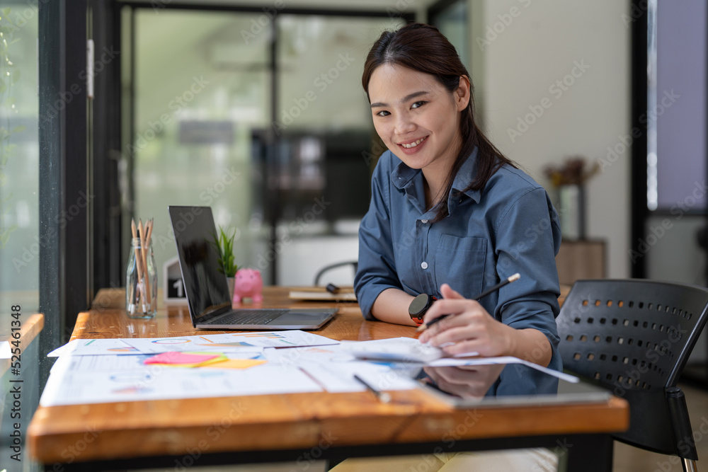 Portrait asian accountant or auditor working with calculator and laptop computer. Portrait asian accountant or auditor working with calculator and laptop computer.