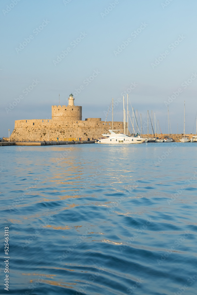 Fort of St. Nicholas in Mandaki Harbor, Rhodes, Greece.the famous deers, one of the island's symbols.Greece. View of famous tourist destination Fort of St. Nicholas in Mandaki Harbor, Rhodes, Greece.the famous deers, one of the island's symbols.Greece. View of famous tourist destination