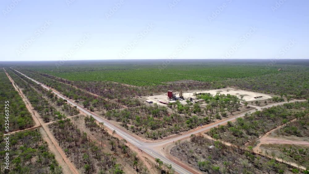 High drone shot of a rural highway intersection next to a field of sandalwood trees. Agricultural land growing a sandalwood orchard High drone shot of a rural highway intersection next to a field of sandalwood trees. Agricultural land growing a sandalwood orchard