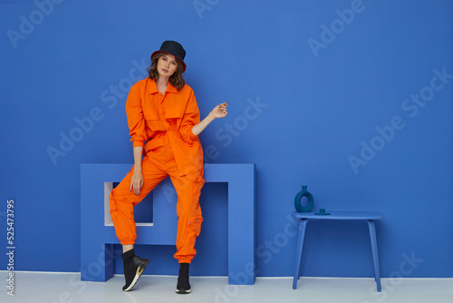 Fashion asian female model in orange trendy suit.