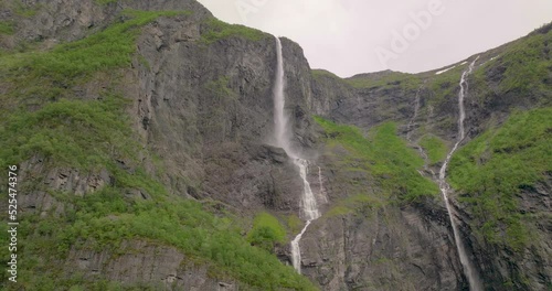 Kjelfossen Waterfall Flowing From Sheer Cliffs Near Gudvangen, Norway. Low Angle photo