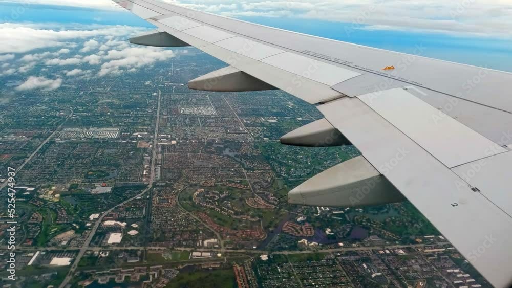 Passenger plane window view moments after takeoff with the view of Mexico city in the background at daytime. Passenger plane window view moments after takeoff with the view of Mexico city in the background at daytime.