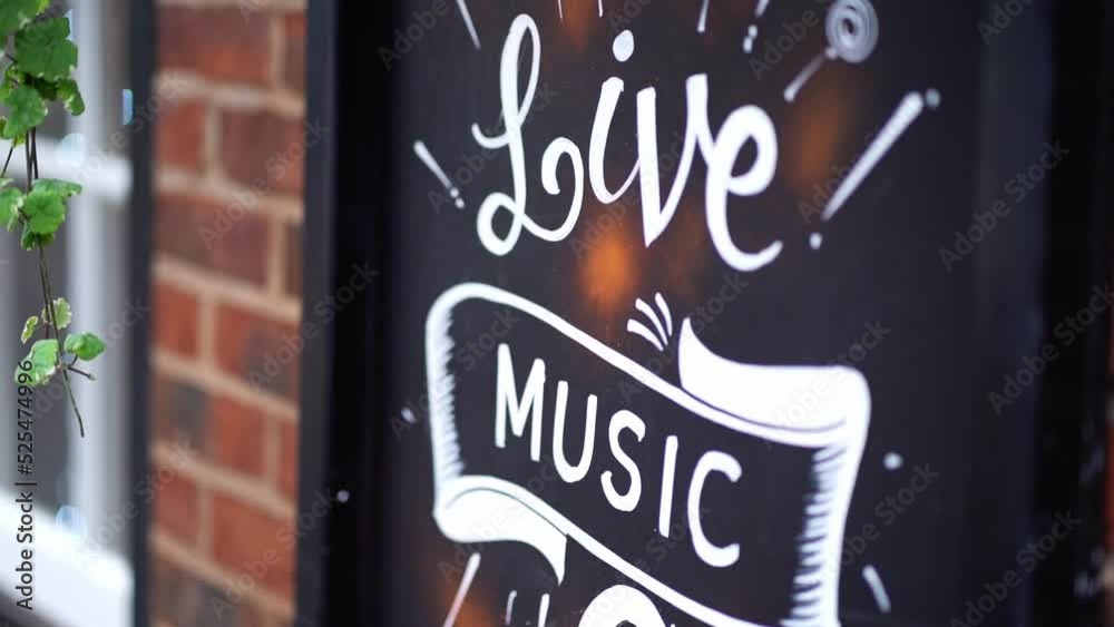A sign outside of a pub promoting Live Music