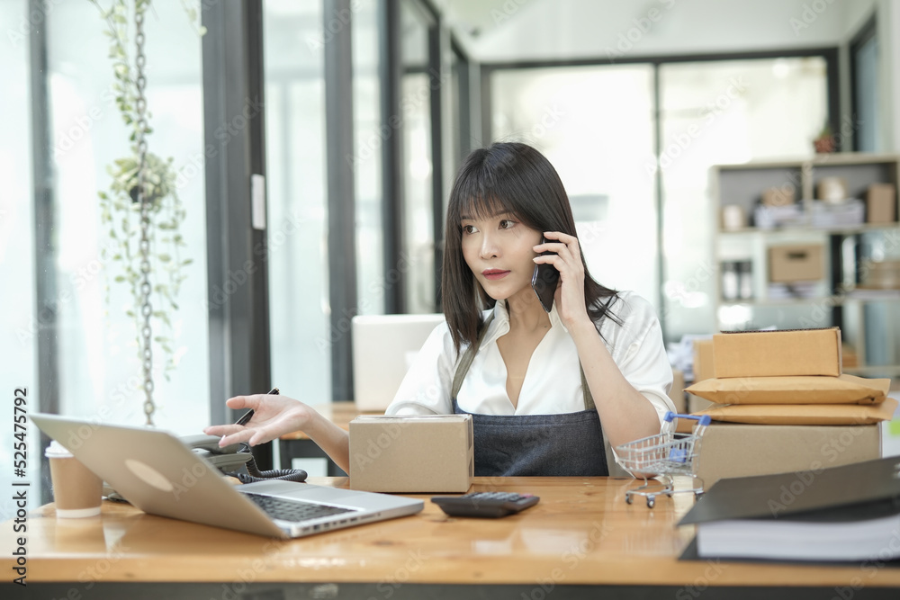 Asian businesswoman using calculator and financial documents at the table office, business financial concept. Asian businesswoman using calculator and financial documents at the table office, business financial concept.