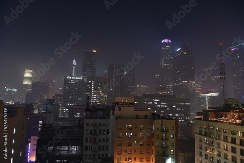 City Night skyline with fog and haze above the buildings of cyberpunk