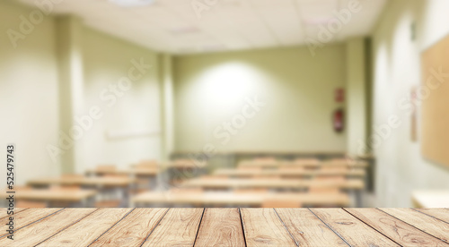 Empty wooden desk space platform with school classroom background for product display © pedro