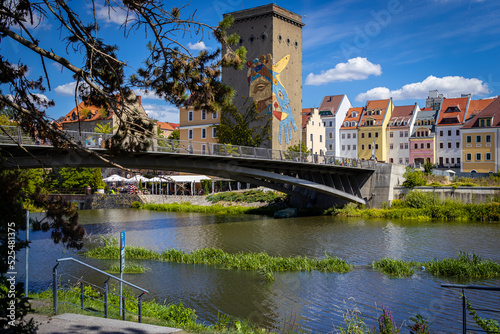 Pedestrian bridge over the Neisse River at the Polish-German border in Zgorzelec with historic buildings in the background