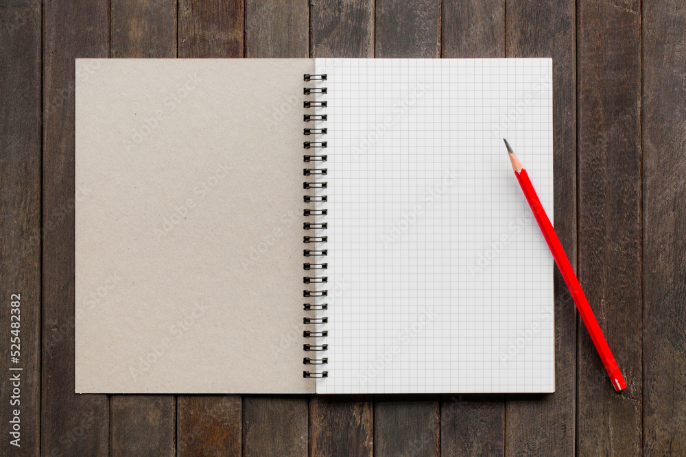Open notebook with white lined pages and pencil on book Open notebook with white lined pages and pencil on book