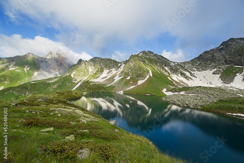 Fototapeta Naklejka Na Ścianę i Meble -  A beautiful mountain lake against the backdrop of a mountain range.