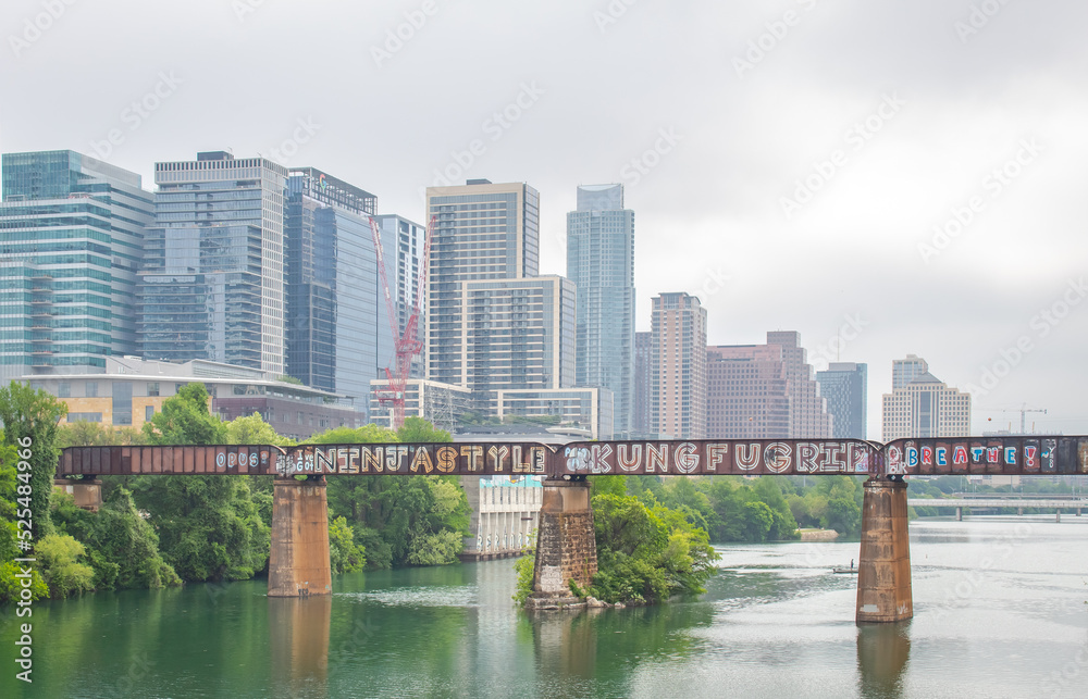 Naklejka premium Downtown Austin Texas skyline buildings over Lady Bird Lake on a cloudy grey cloudy foggy day