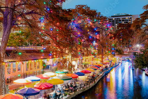 Colorful LED Christmas lights at the restaurants at the  San Antonio Riverwalk on a December Texas evening photo