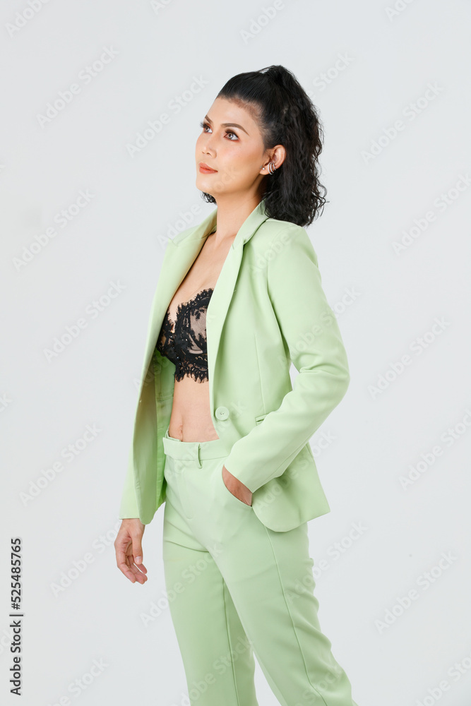 Portrait isolated cutout studio shot of Asian sexy curly hair fashion  businesswoman in green suit with