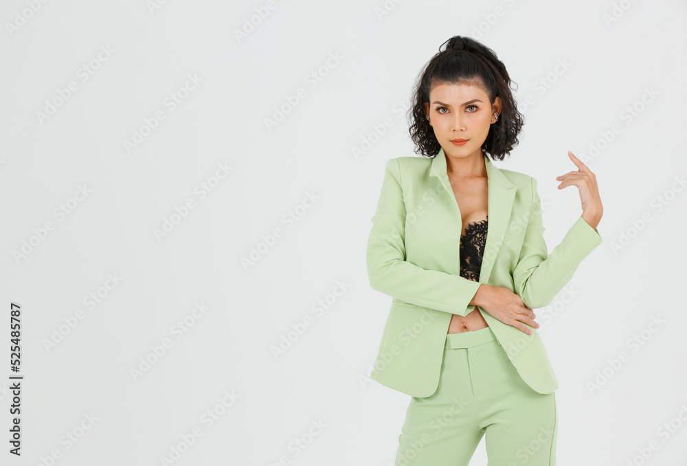 Portrait isolated cutout studio shot of Asian sexy confident curly hair fashion businesswoman in green suit with black lace lingerie crop top bra standing look at camera posing on white background Portrait isolated cutout studio shot of Asian sexy confident curly hair fashion businesswoman in green suit with black lace lingerie crop top bra standing look at camera posing on white background