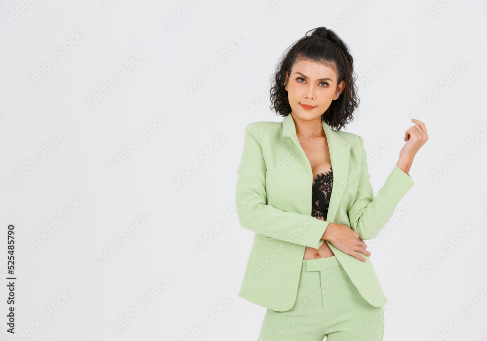 Portrait isolated cutout studio shot of Asian sexy confident curly hair fashion businesswoman in green suit with black lace lingerie crop top bra standing look at camera posing on white background