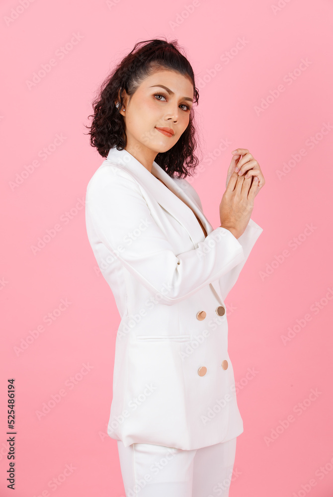 Portrait studio shot of Asian sexy curly hairstyle professional successful businesswoman in white fashionable casual suit with lace lingerie crop top bra standing look at camera on pink background Portrait studio shot of Asian sexy curly hairstyle professional successful businesswoman in white fashionable casual suit with lace lingerie crop top bra standing look at camera on pink background