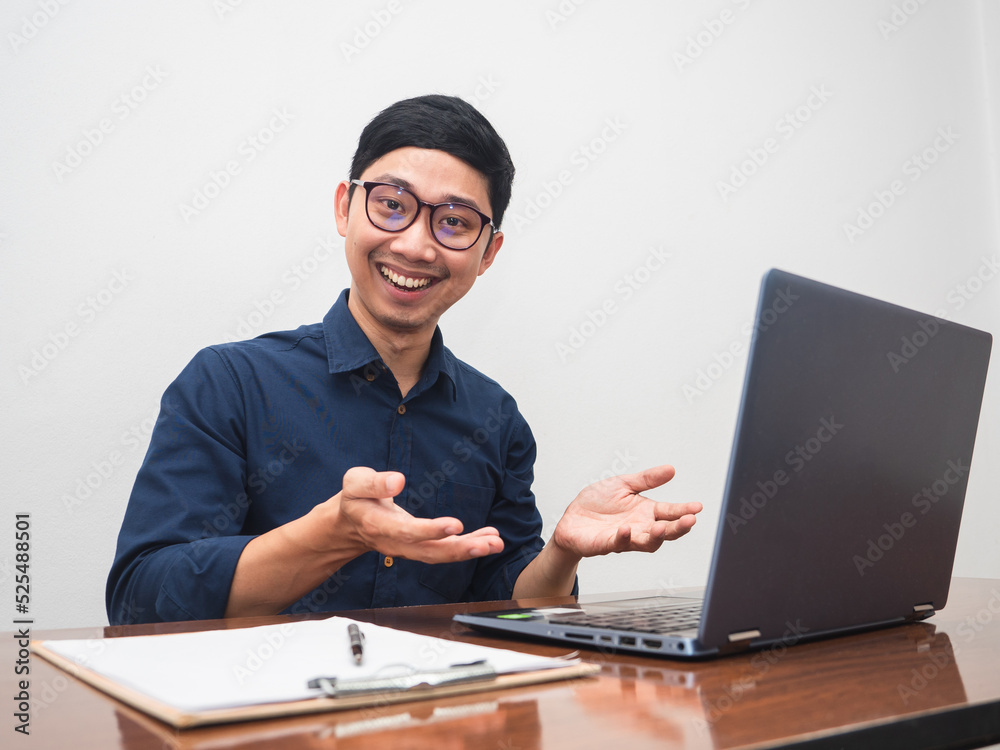 Businessman wear glasses sit at workplace table gesture suggest happy smile Businessman wear glasses sit at workplace table gesture suggest happy smile