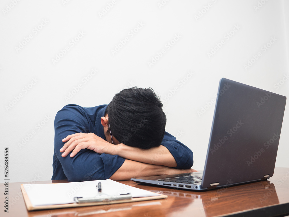 Businessman work hard and feels tried at working table white background Businessman work hard and feels tried at working table white background