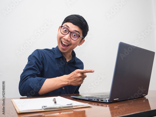 Businessman point finger at his laptop feels amazed