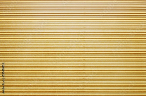 Corrugated gold roller shutter texture. Glitter gold door for background. 