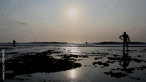 people on the beach at sunset