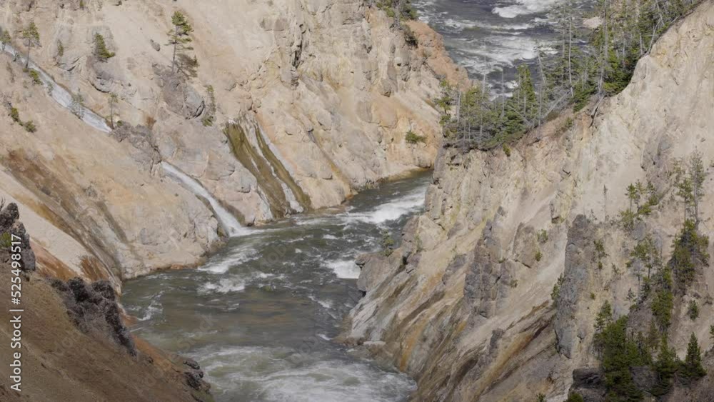 Rocky Canyon and River in American Landscape. Grand Canyon of The Yellowstone. Yellowstone National Park. United States. Nature Background. Slow Motion Rocky Canyon and River in American Landscape. Grand Canyon of The Yellowstone. Yellowstone National Park. United States. Nature Background. Slow Motion