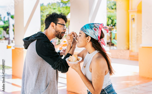 Canvas Print A couple eating shaved ice in a square, Young couple eating shaved ice together