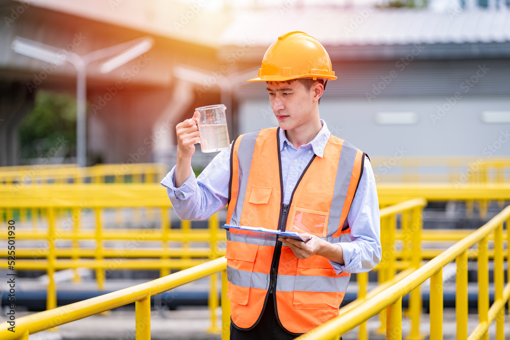 Worker under checking the waste water treatment pond industry large to control water support industry.	