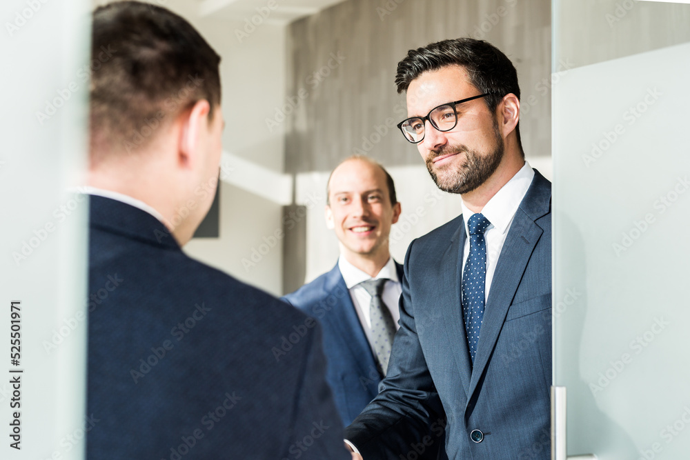 Group of confident business people greeting with a handshake at business meeting in modern office or closing the deal agreement by shaking hands. Group of confident business people greeting with a handshake at business meeting in modern office or closing the deal agreement by shaking hands.