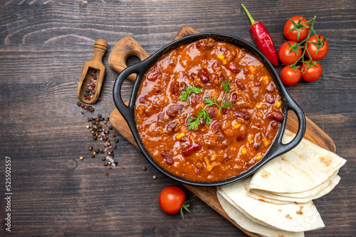 Bean and corn soup or ragout, red bean stew  on a wooden background. Food Protein Vegan dish photo