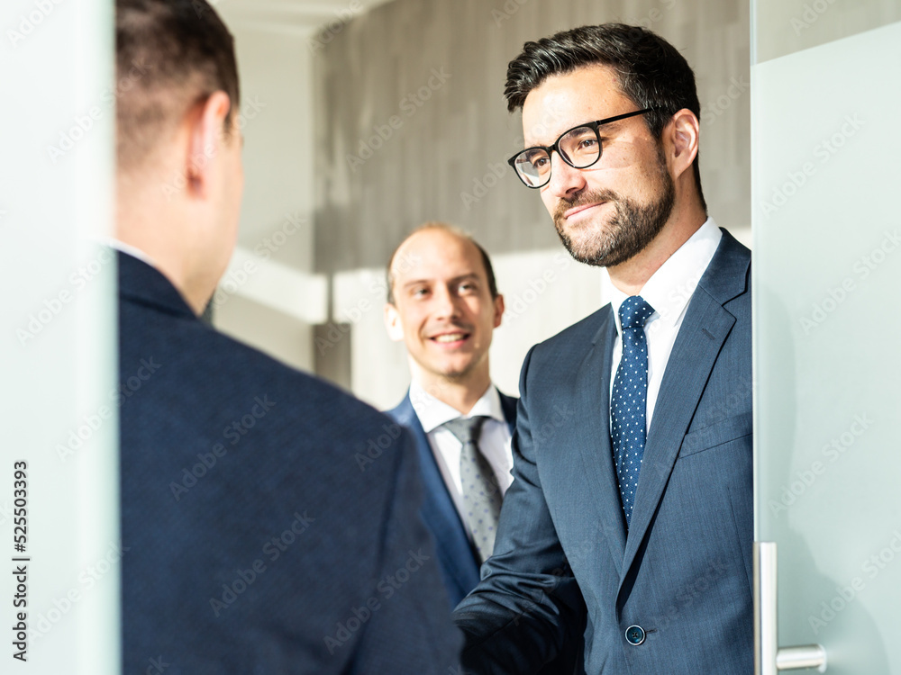 Group of confident business people greeting with a handshake at business meeting in modern office or closing the deal agreement by shaking hands. Group of confident business people greeting with a handshake at business meeting in modern office or closing the deal agreement by shaking hands.