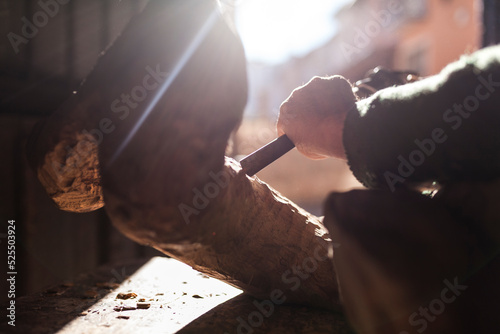 Elderly carpenter working with wood photo