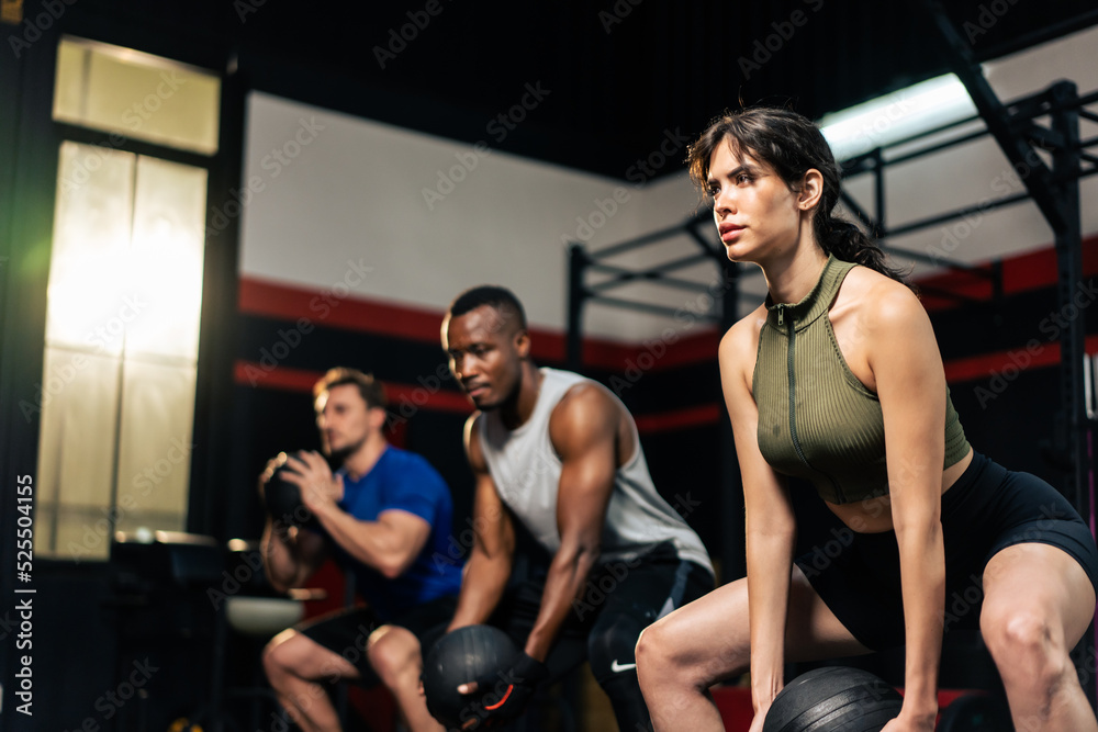 Group of young athlete people doing exercise together in fitness club.