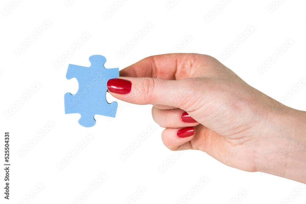 Female hand holding the missing piece of jigsaw puzzle Female hand holding the missing piece of jigsaw puzzle